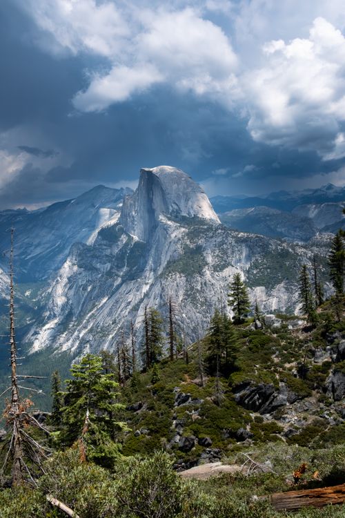 Free Majestic Half Dome in Yosemite Valley under dramatic skies, perfect for nature and travel themes. Stock Photo