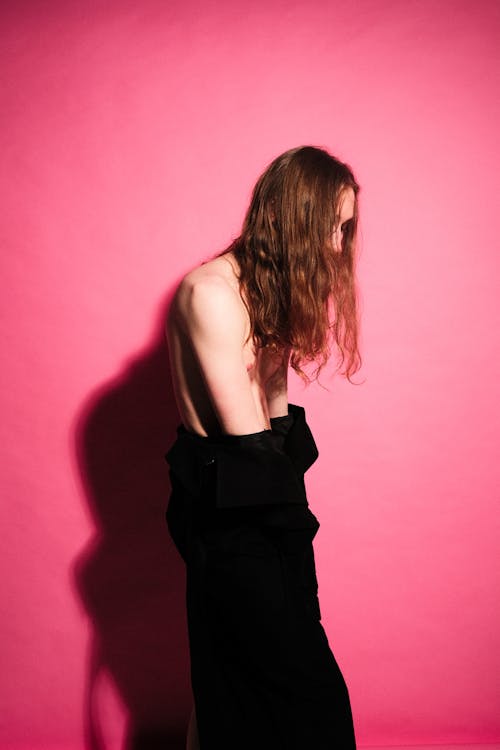 Shirtless Model Posing against Pink Background