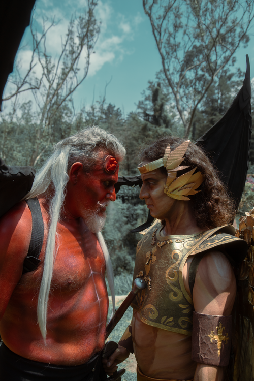 Free Fantasy scene of angel and demon confrontation in a forest setting, capturing dramatic tension. Stock Photo