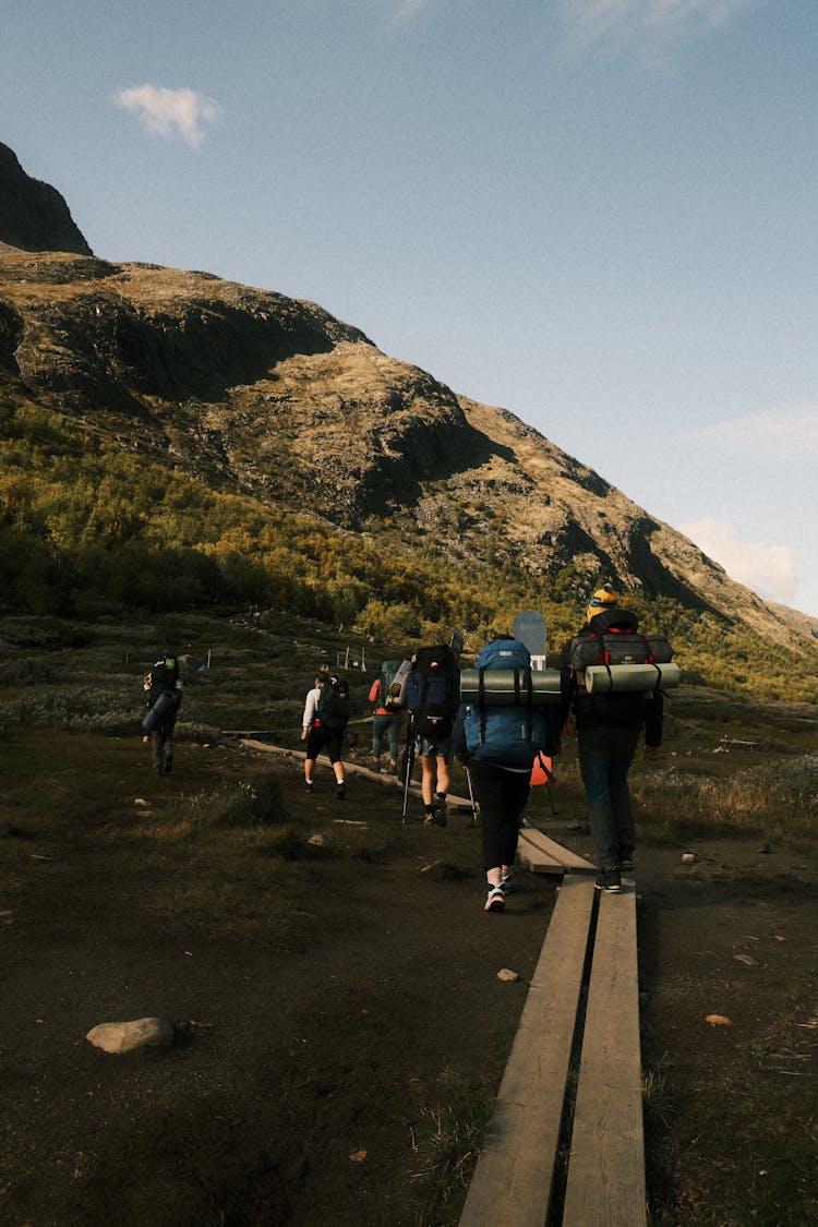 People Hiking With Backpacks