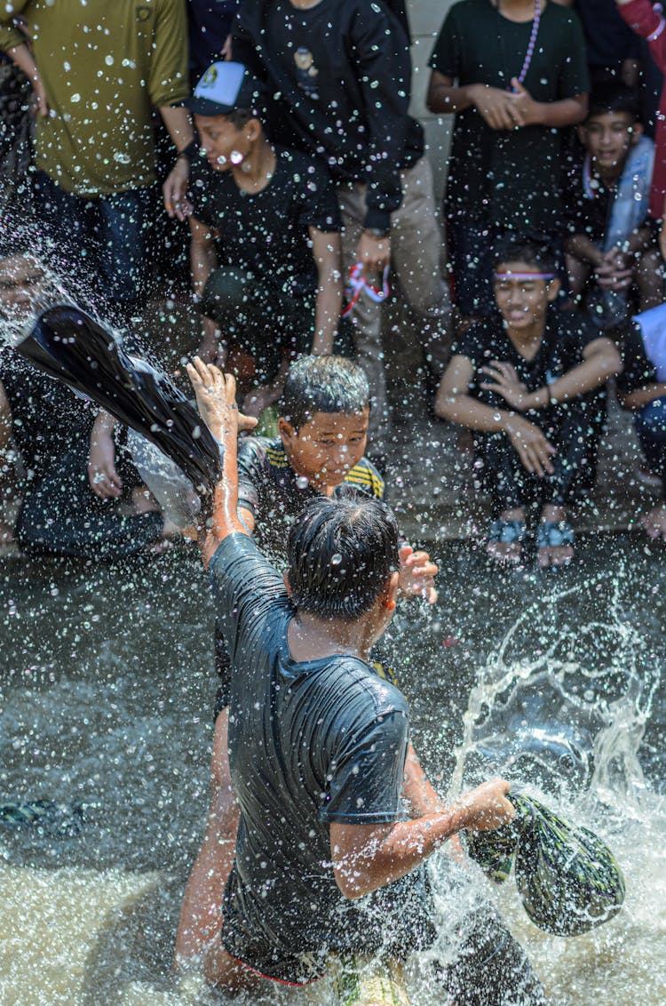 Teenager Boys Splashing In Water