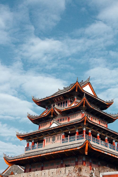Free A beautiful traditional pagoda with ornate eaves set against a backdrop of clear blue skies. Stock Photo