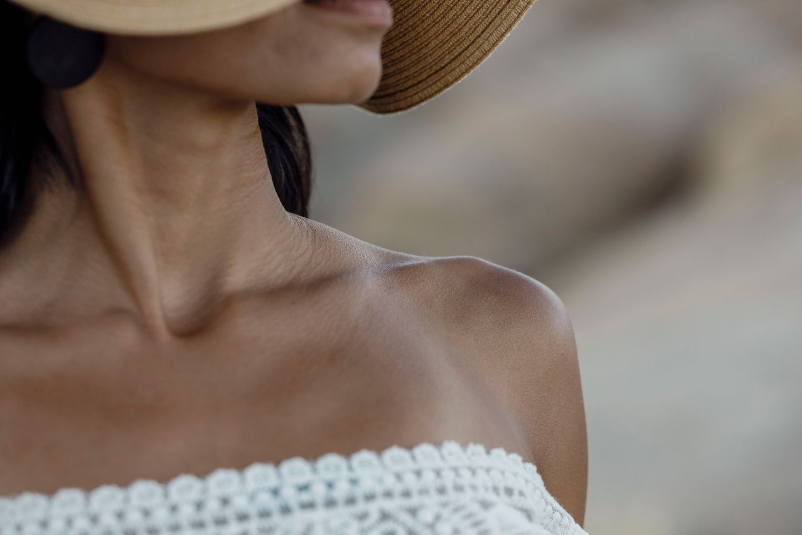 Woman wearing a straw sun hat and strapless