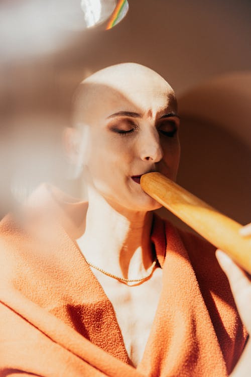 Bald Woman Holding a Baguette 