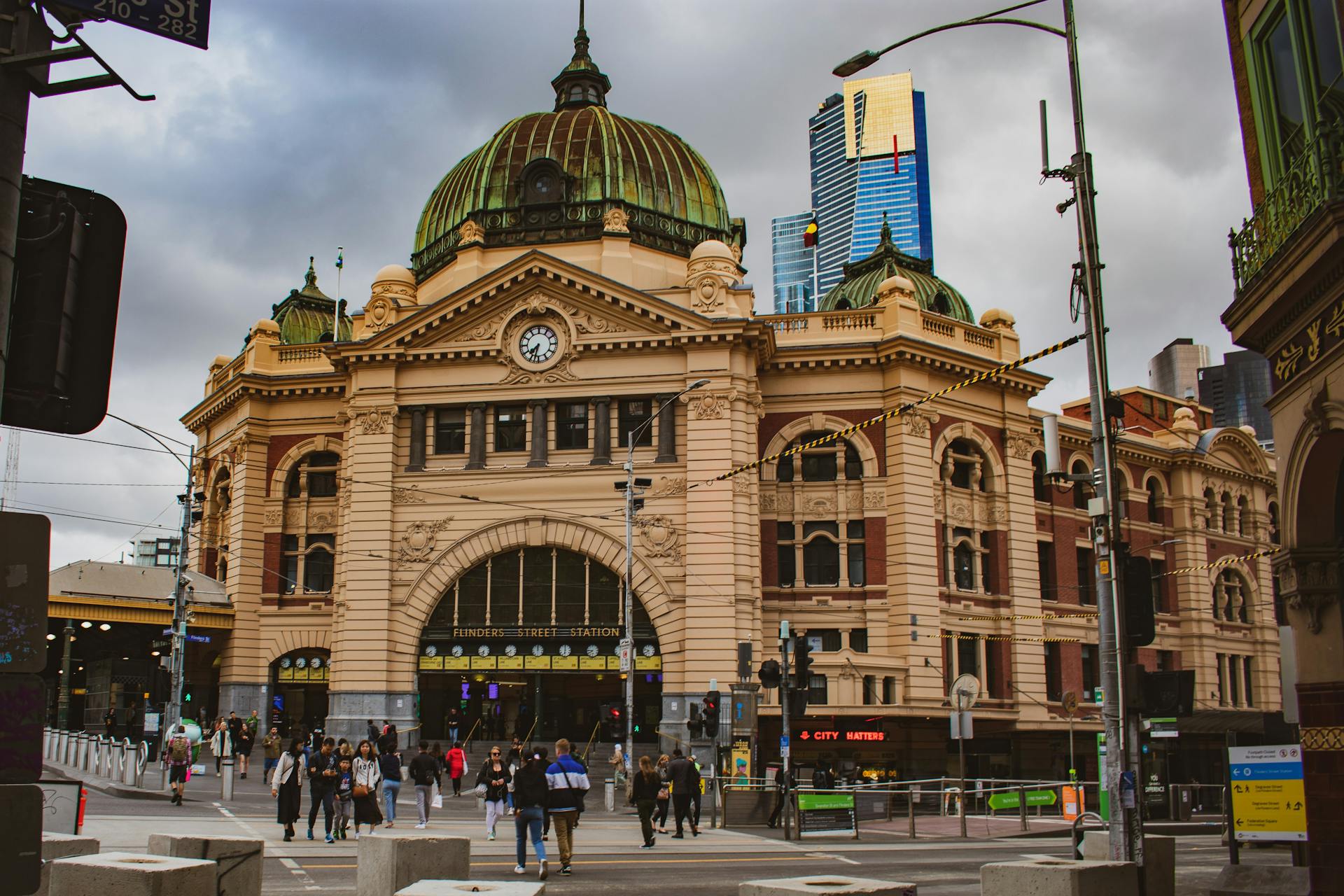 Iconic Flinders Street Station in Melbourne, capturing urban life and historical architecture.
