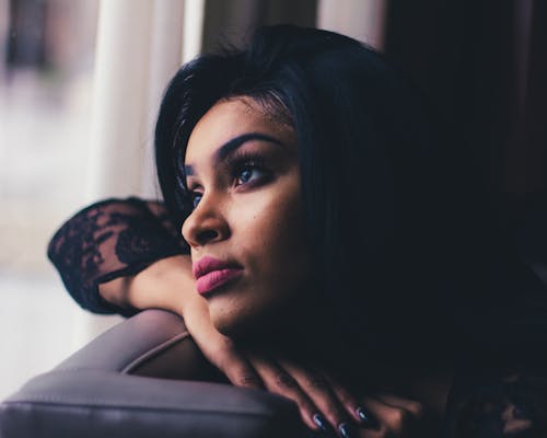 Close-Up Photo of Woman Leaning on Sofa