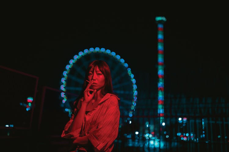 Woman Posing In Funfair In Red Light