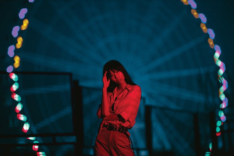 Woman Posing In Funfair In Red Light