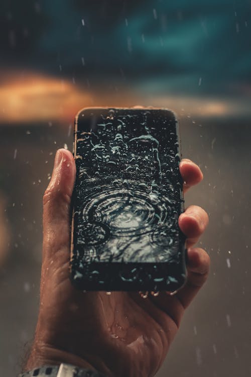 Free Photo of Person Holding Wet Smartphone Stock Photo