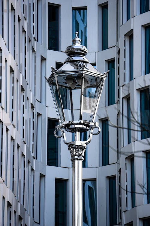 Decorative Retro Street Lamp on the Background of a Modern Building