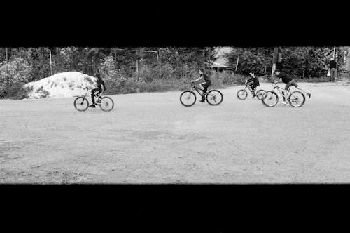 Boys Riding Bicycles in Black and White