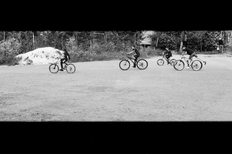 Boys Riding Bicycles In Black And White