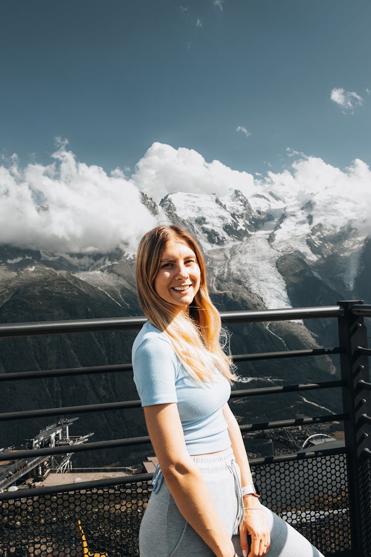 Smiling Tourist At A Scenic Overlook In The Mountains