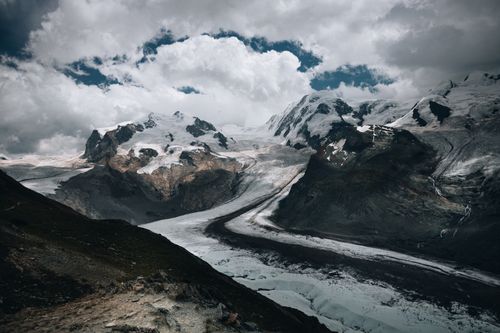 Free Dramatic landscape of the Mer de Glace glacier in the French Alps under cloudy skies. Stock Photo