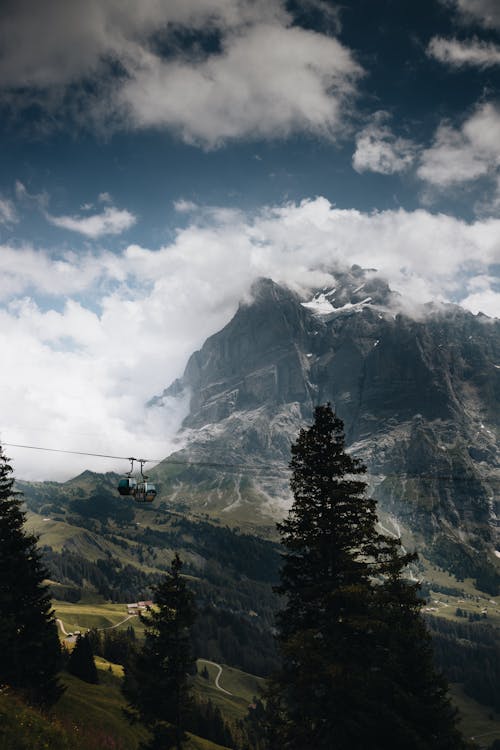 Gondolas Running over Valley against Magnificent Mountains