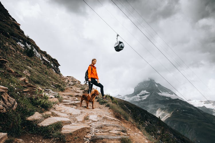 Woman With Dog In A Mountain Valley