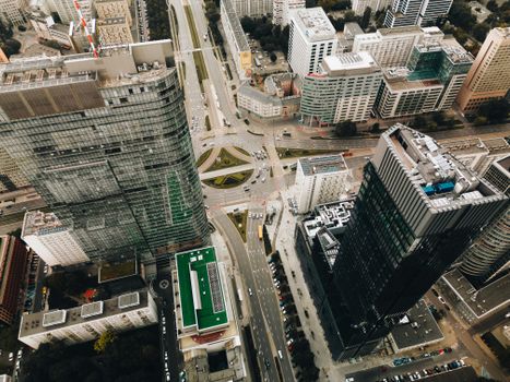 Stunning aerial view of Warsaw's modern cityscape featuring skyscrapers and a bustling roundabout.