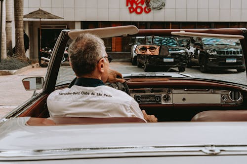 Man in Mercedes Shirt Sitting in Cabriolet