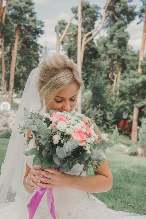 Blonde Bride Holding Flowers Bouquet