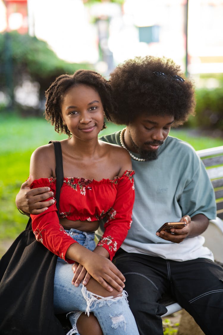 Young Couple Sitting On A Bench