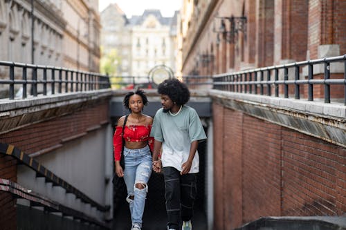 Couple Holding Hands Walking out of Underground Passage