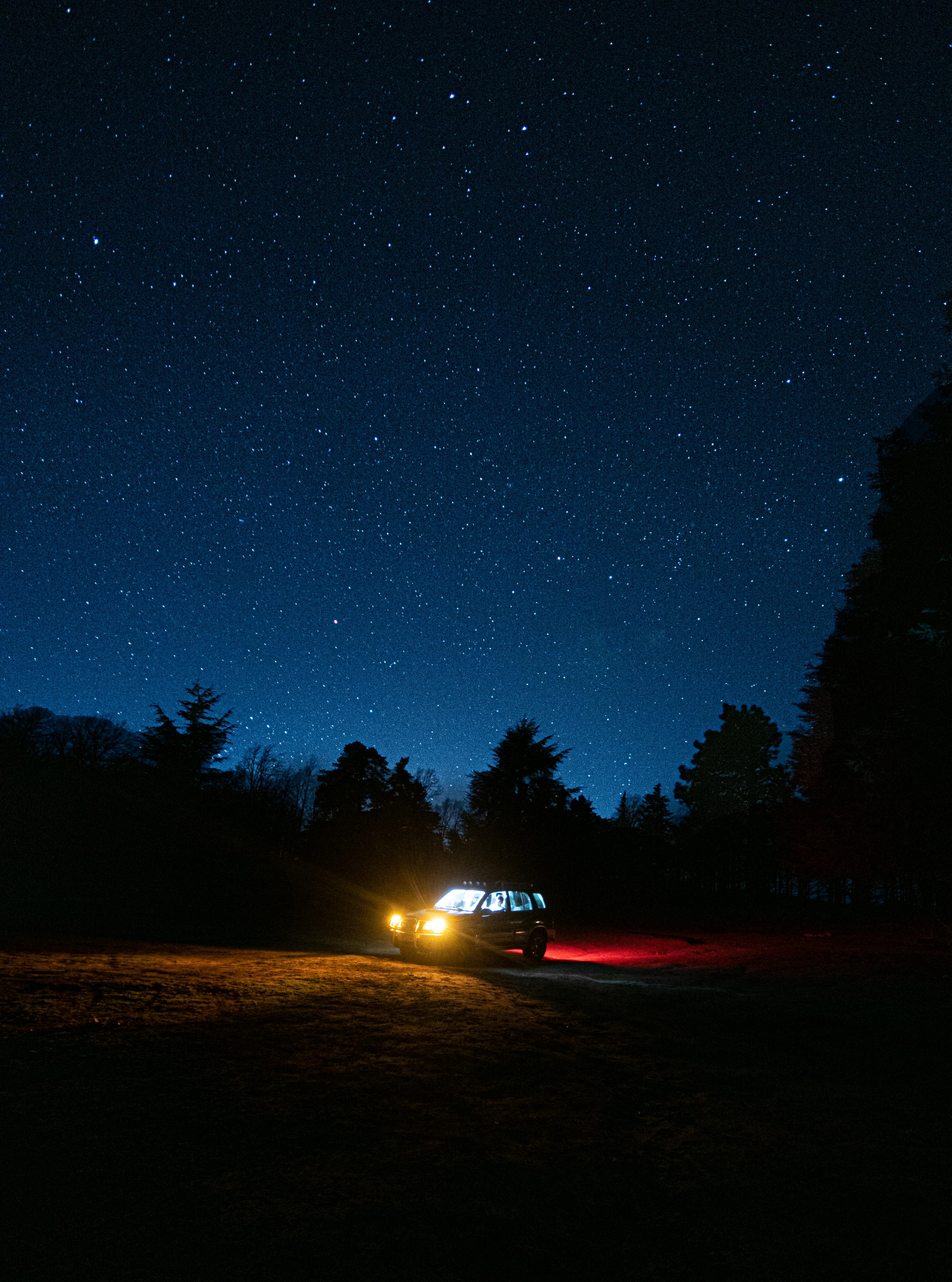 Dirty big car in the mountains at night. Concept of travelling, resting on  nature and looking at starry sky with car Stock Photo - Alamy