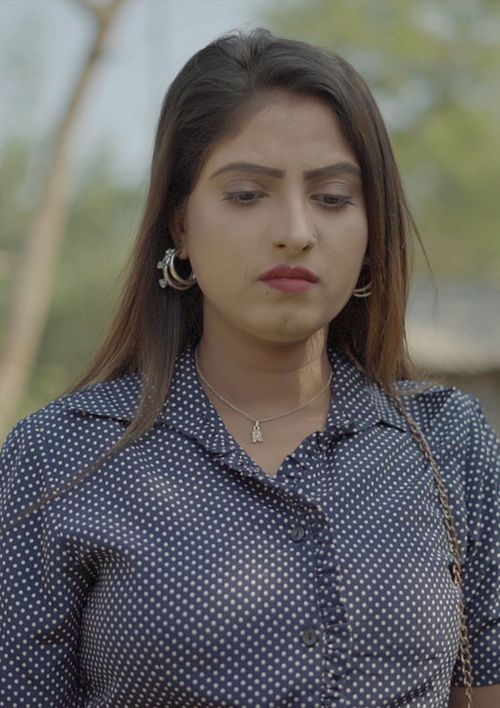 Free Woman outdoors with a contemplative expression in a polka dot shirt, capturing a thoughtful moment. Stock Photo