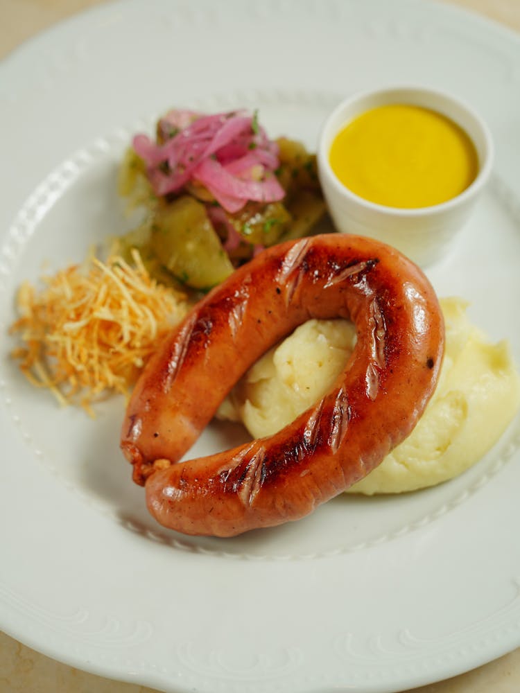 Mashed Potatoes, Sausage And Vegetables On A Plate