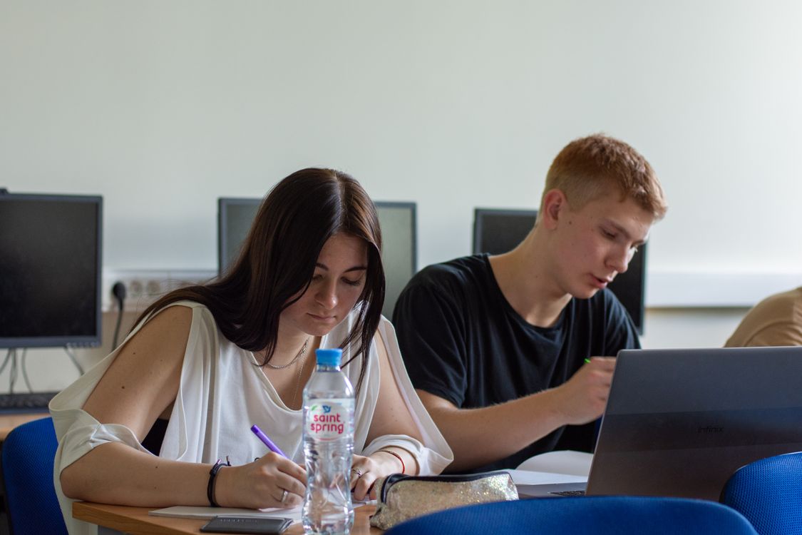 Students studying with technology in a modern classroom setting