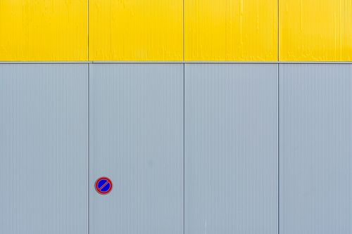 Free Minimalist industrial wall design with contrasting colors and no parking sign. Stock Photo