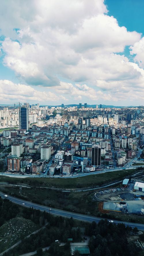 Free Aerial view of a vibrant cityscape featuring modern architecture and urban skyline. Stock Photo
