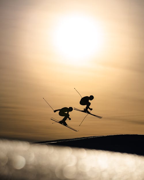 Silhouette of People Skiing 