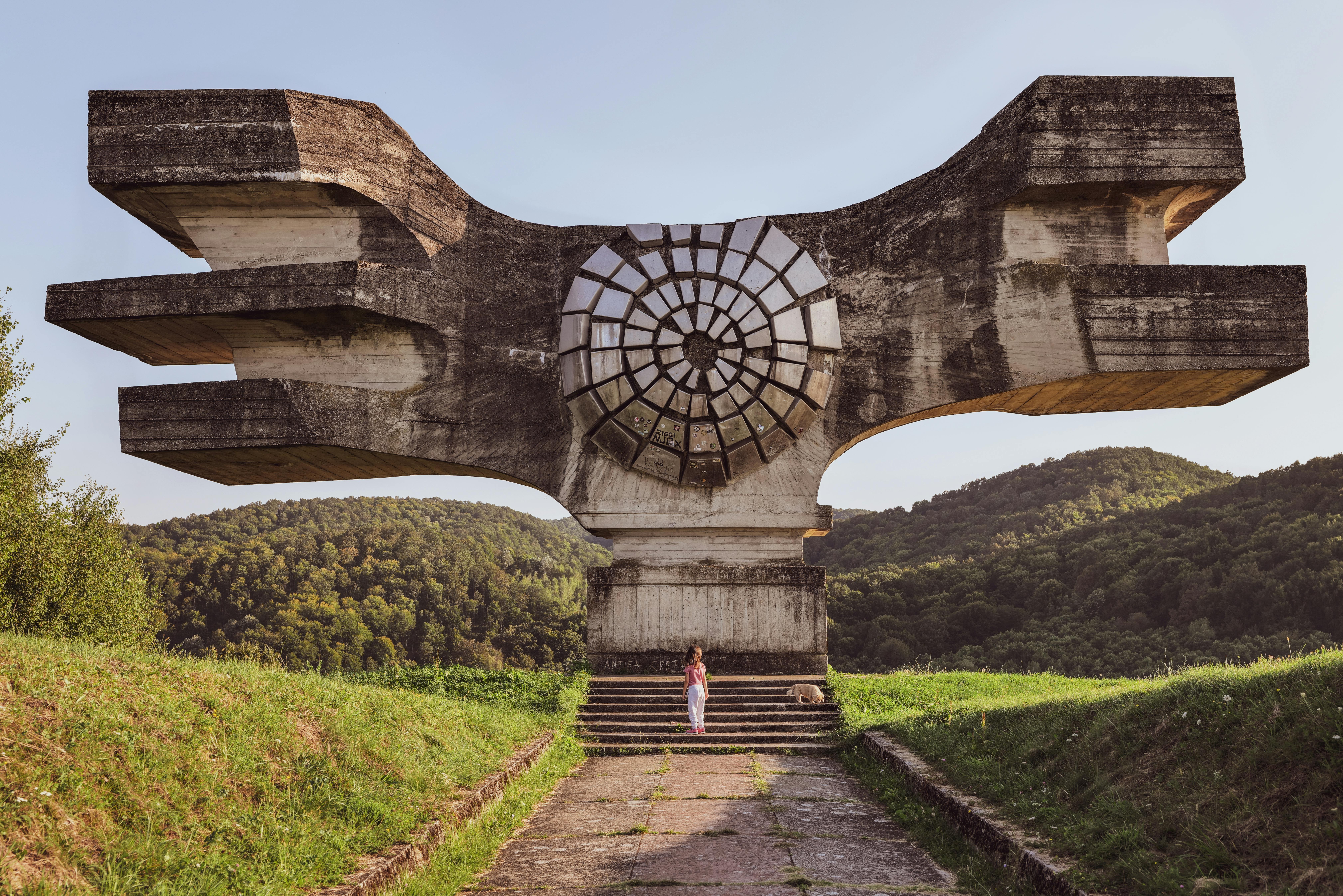 Monument to the Revolution in Podgarić, Croatia, amidst lush greenery.