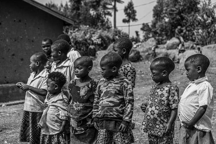 A Group Of Kids Standing Outside 