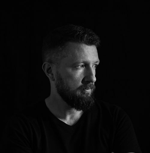 Free Artistic black and white portrait of a bearded man with a contemplative expression. Stock Photo