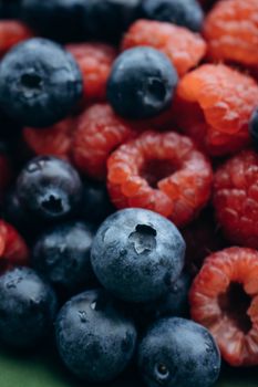 Vibrant close-up shot of fresh blueberries and raspberries, perfect for healthy eating concepts.