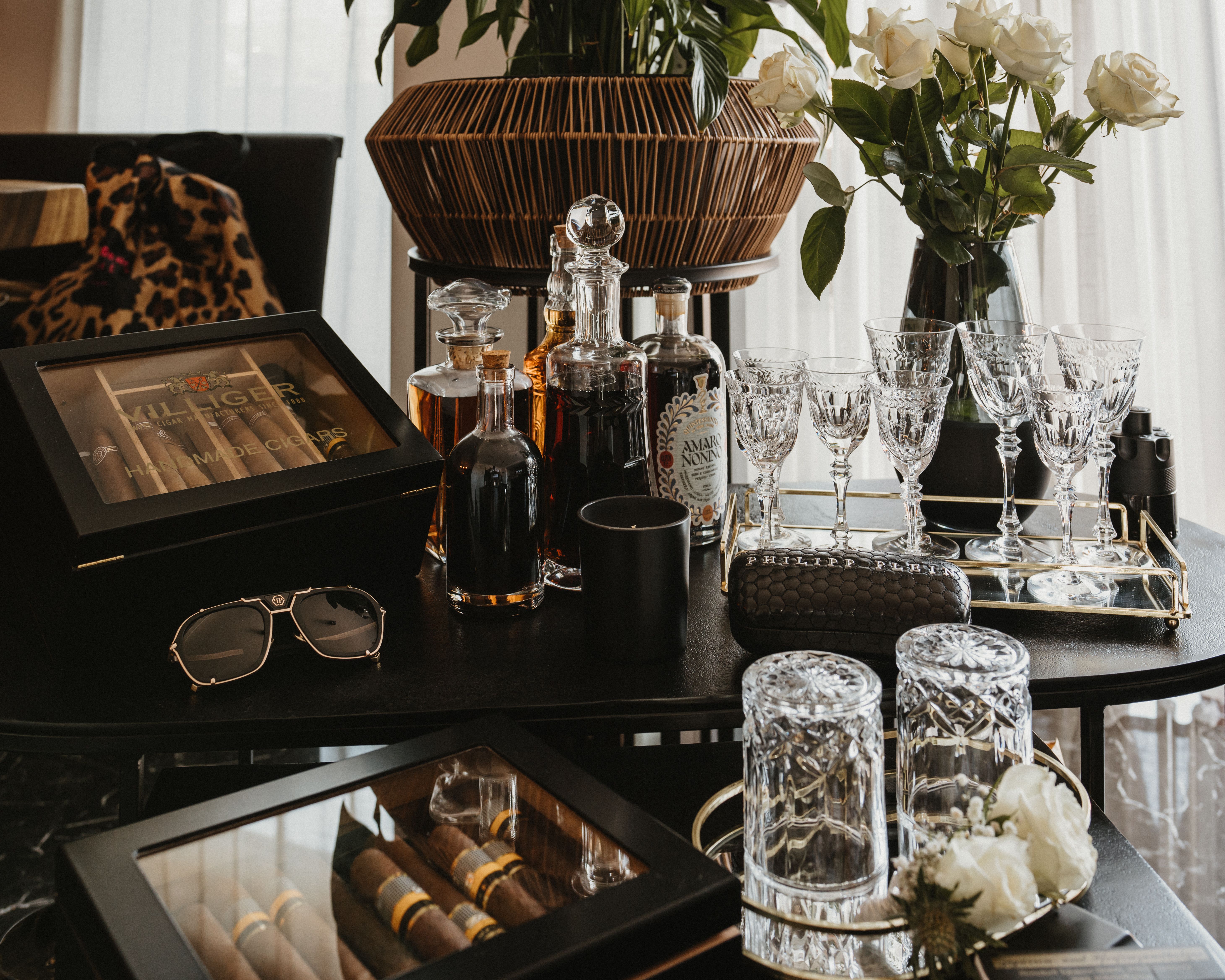 Boxes of Cigars Set on Table Surrounded by Glassware · Free Stock Photo
