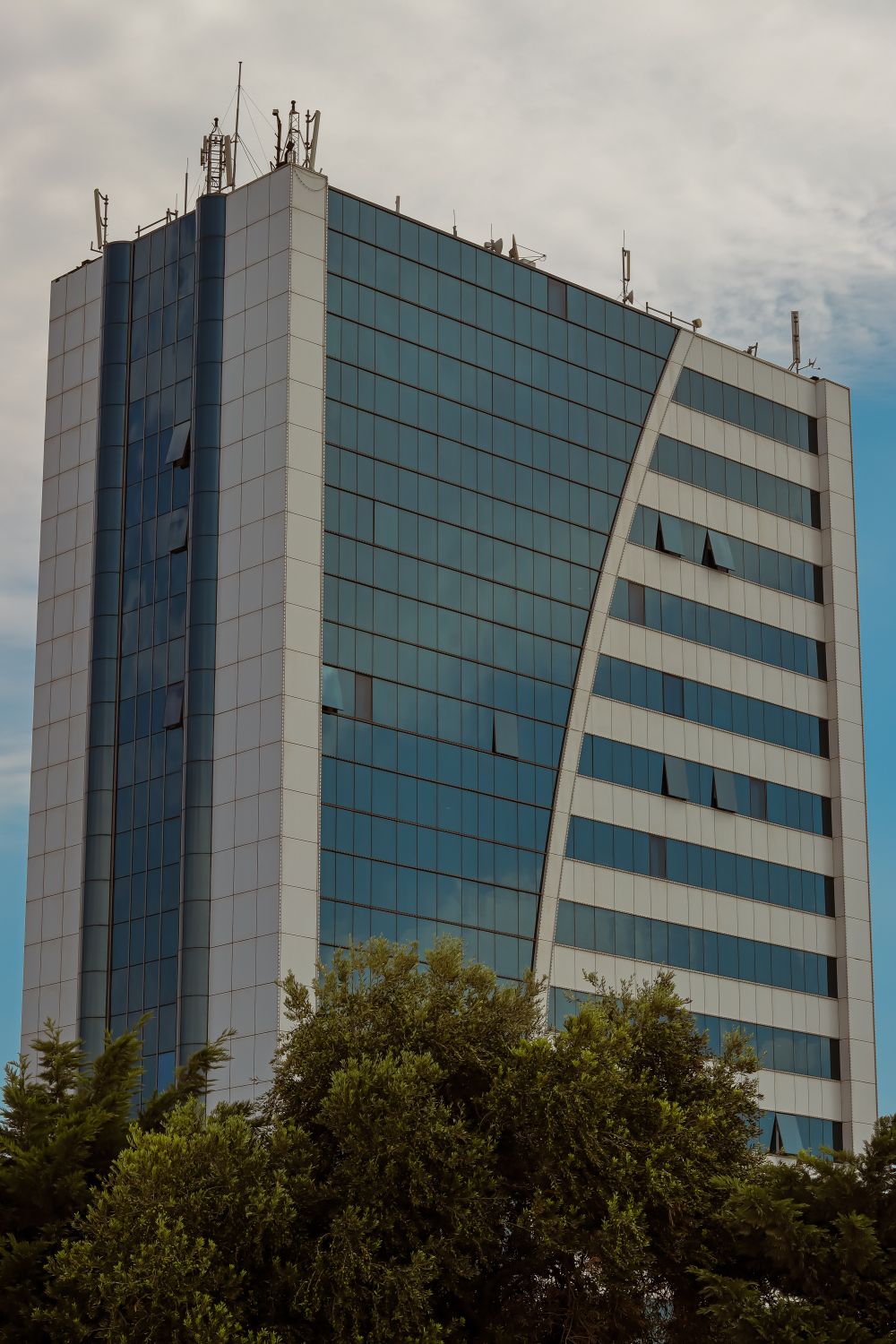 Glass facade of a modern office tower in a business district