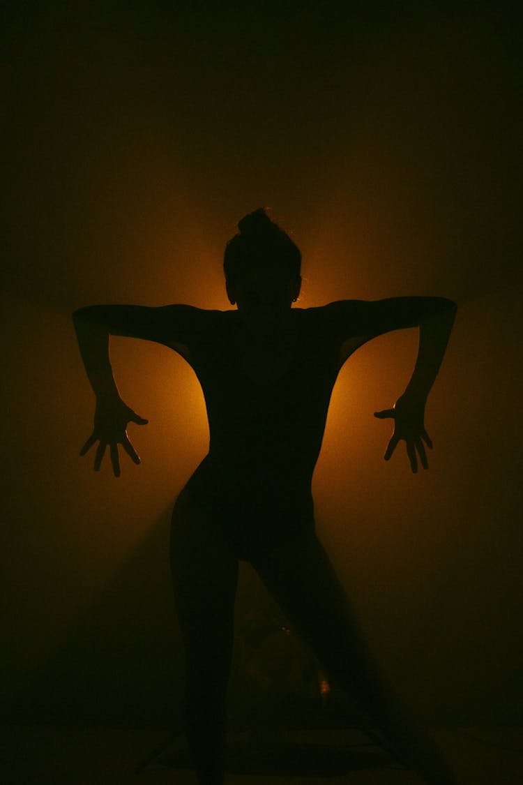 Silhouette Of Person Posing With Arms Spread Out