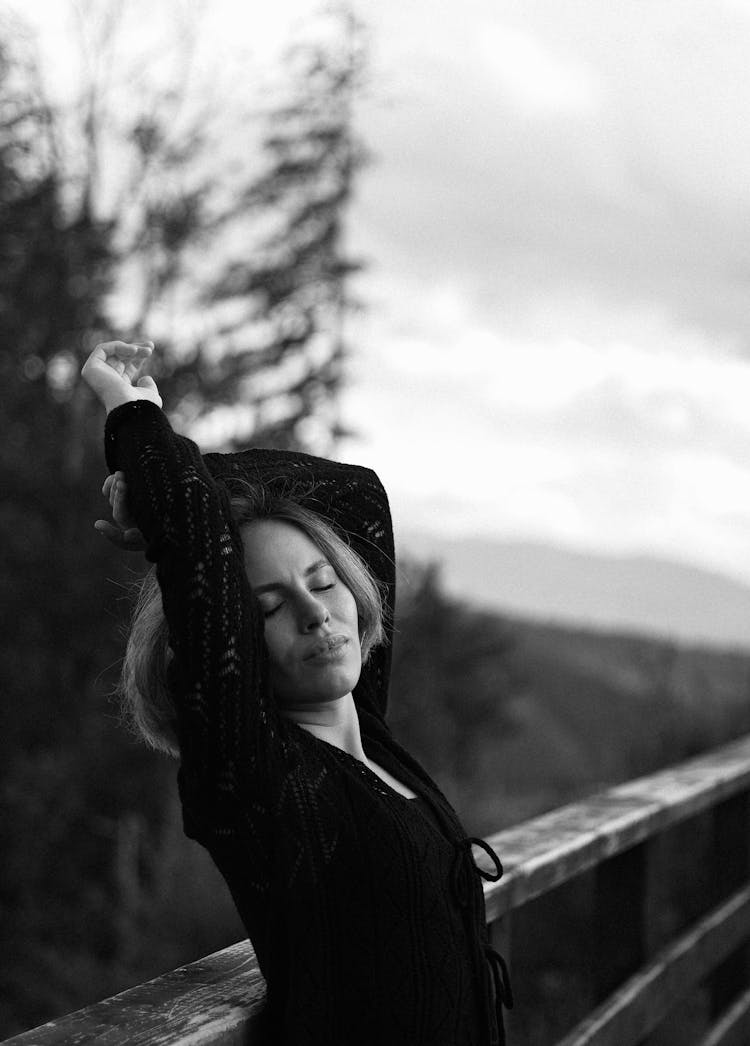 Woman In Black Posing By Railing