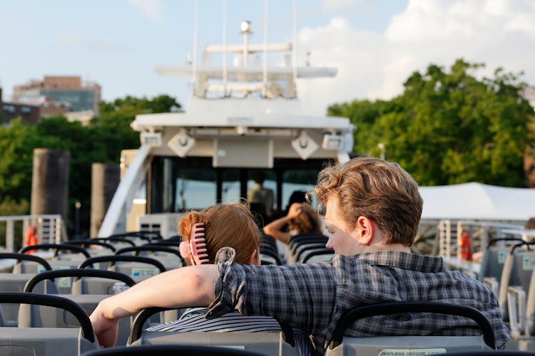 Woman And Man Sitting On Seats On Vessel