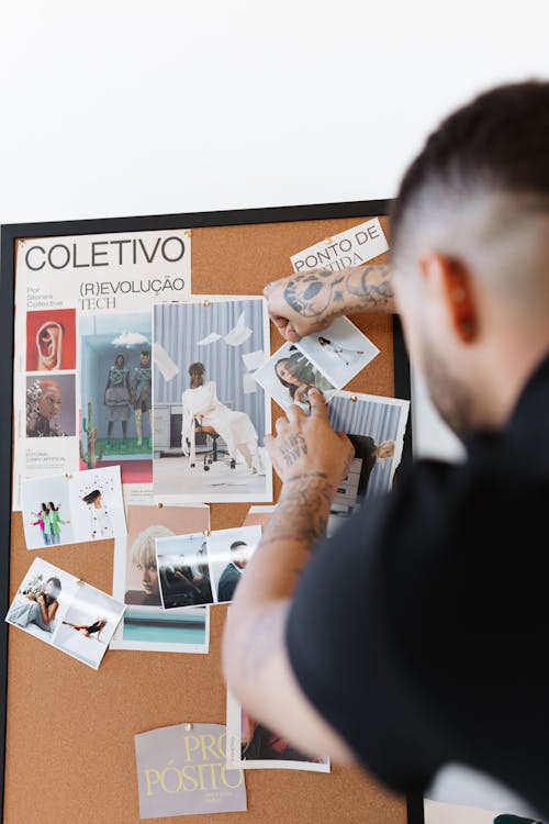 Man Pinning Notes to a Bulletin Board