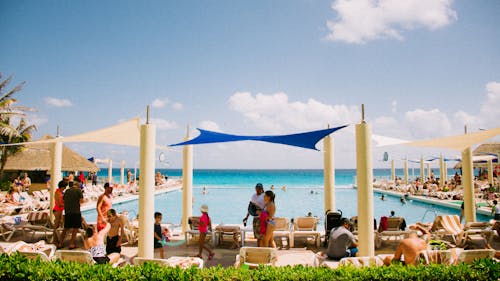 People Relaxing by the Pool on the Beach 