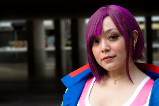 Close-up portrait of an adult woman with bright purple hair, outdoors in Merida, Mexico.