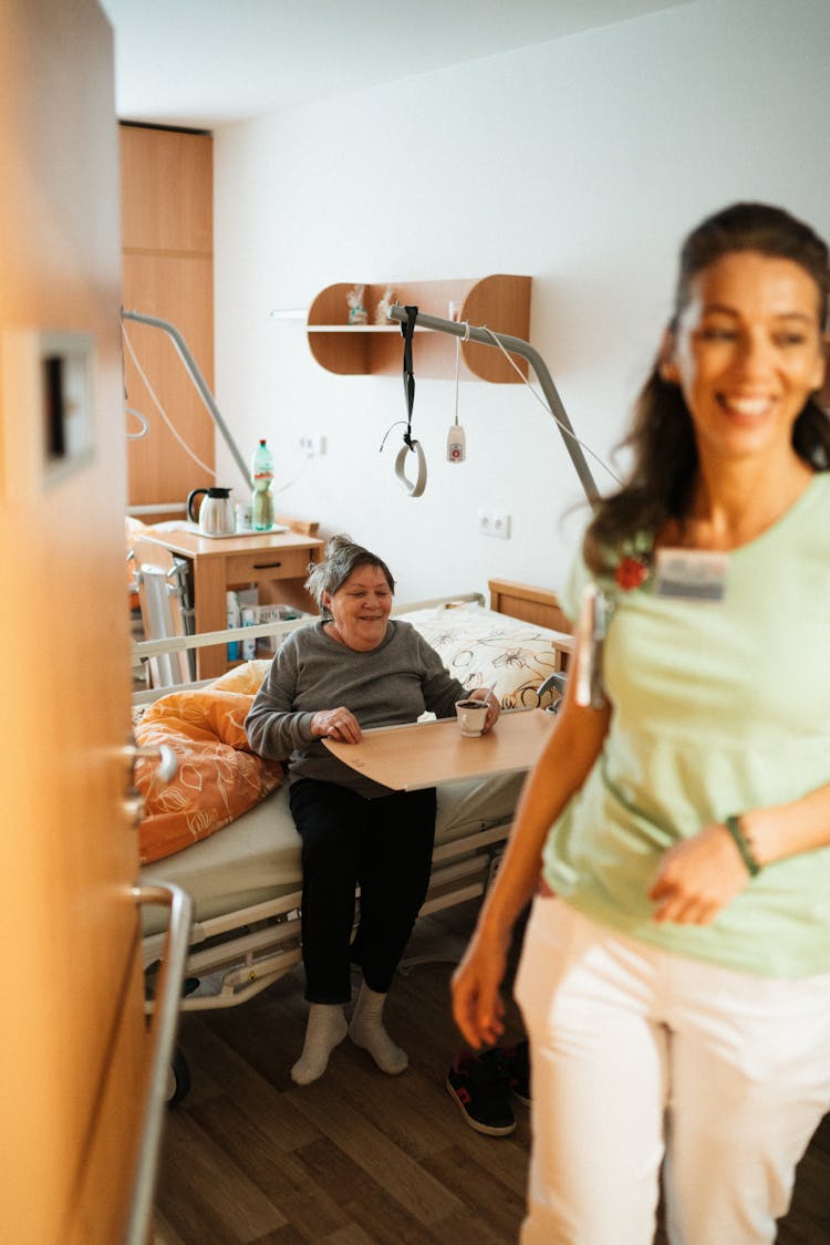 Smiling Nurse And Patient In Room