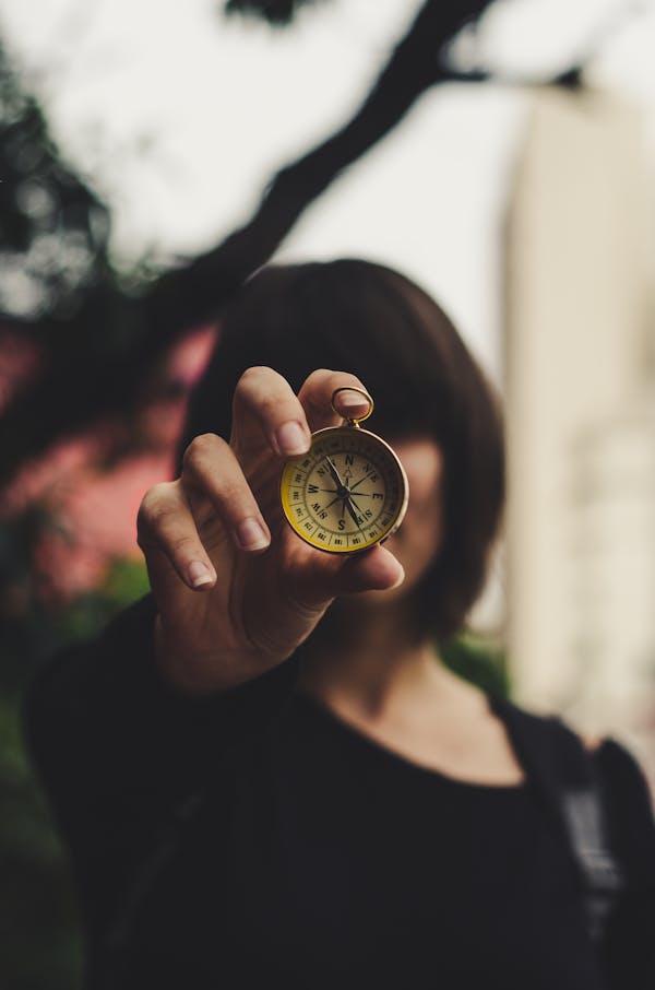 Photo of Woman Holding Compass