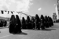 Black and white portrayal of women participating in Ashura mourning ceremony in Istanbul.