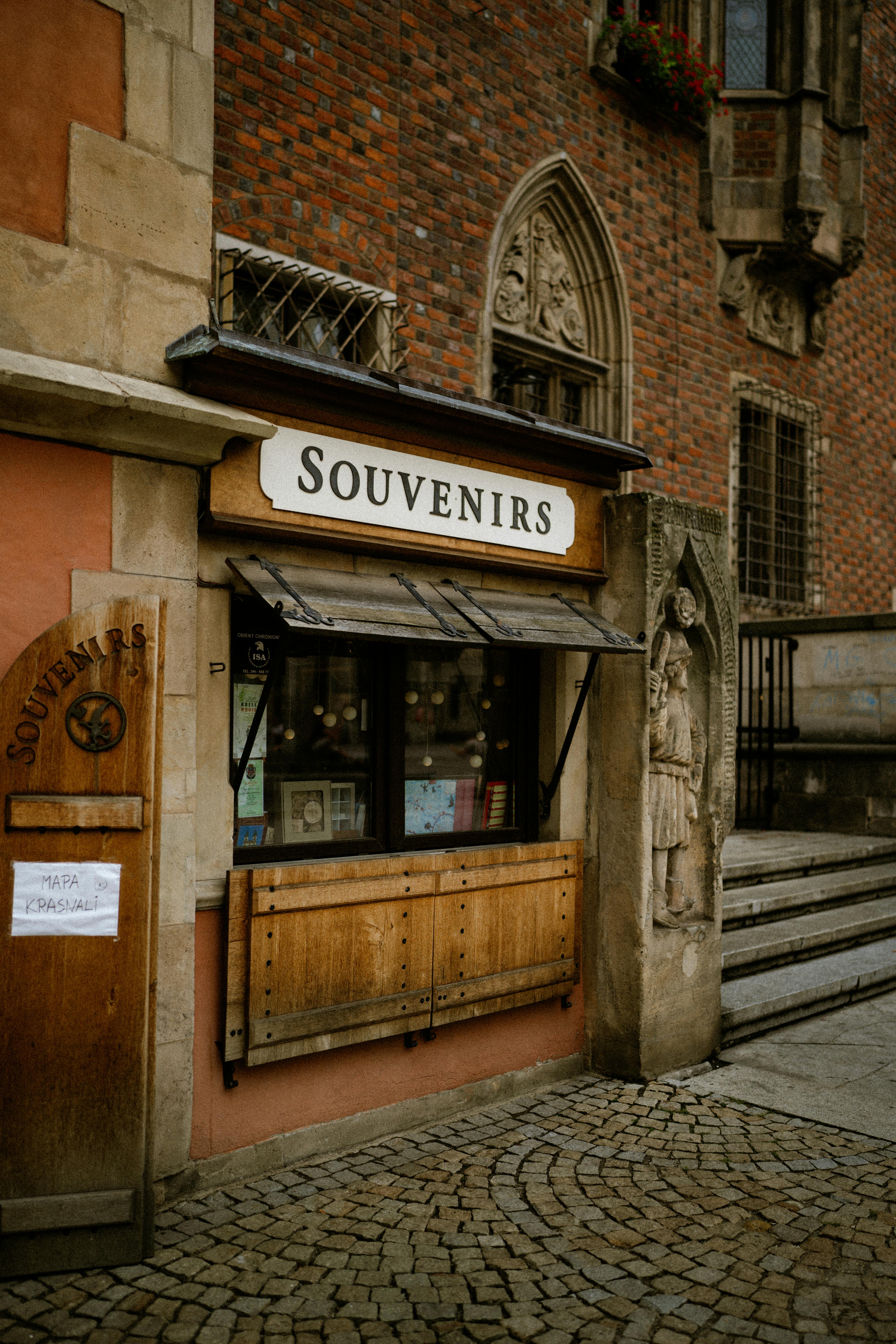 A quaint souvenir shop with a classic brick facade in a historic city setting.