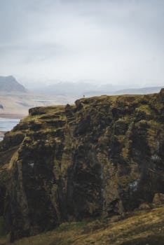 Breathtaking view of a vast cliff with misty seashore in the background, capturing the essence of nature's grandeur.