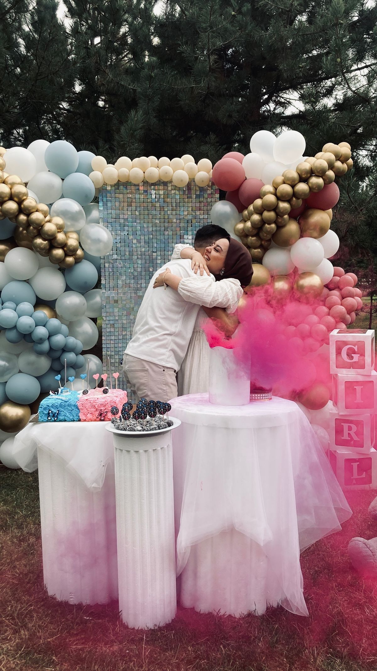 Baby shower photo booth ideas with a gender reveal confetti moment and pink smoke burst